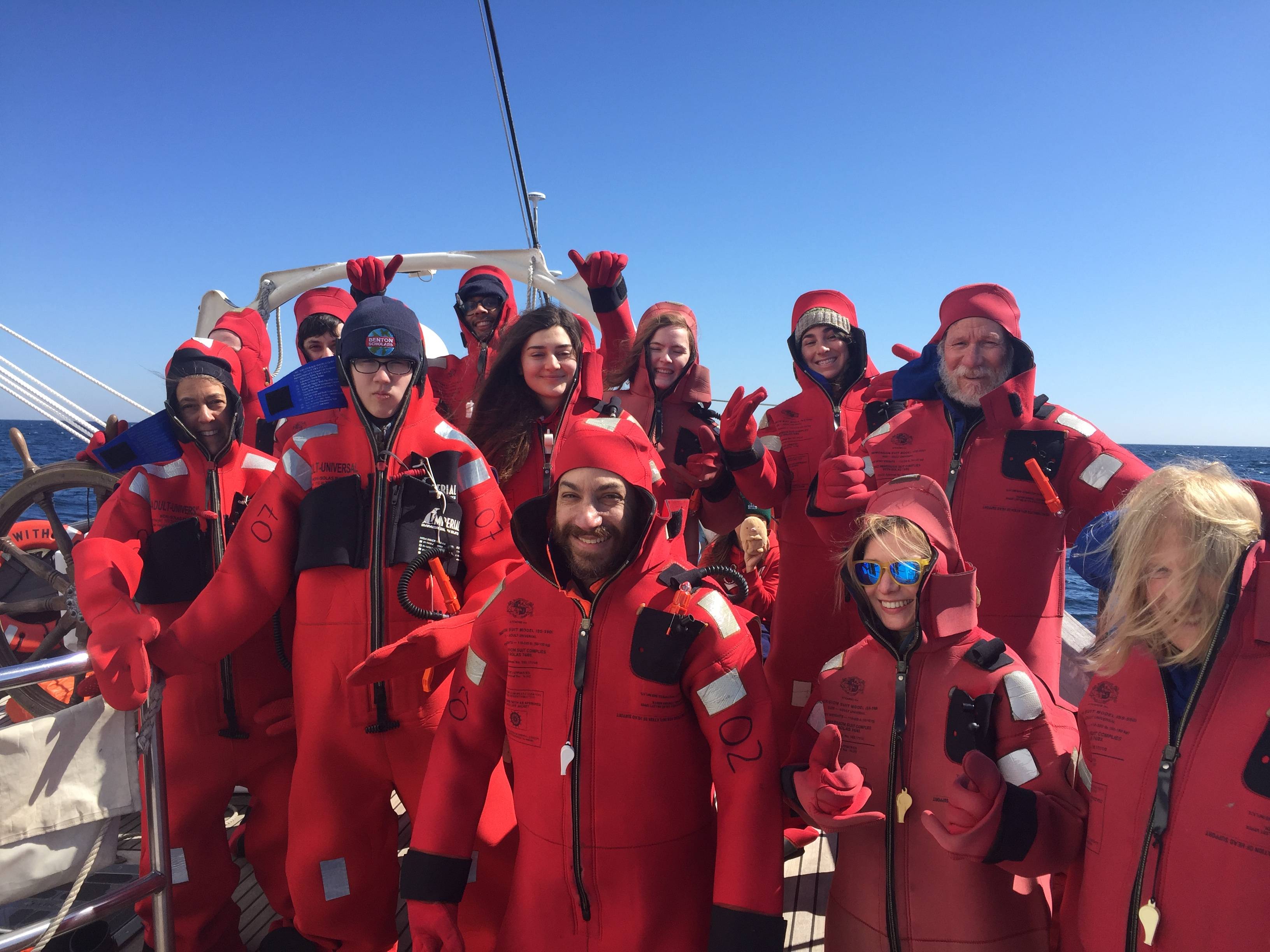 Benton scholars in red "gumby" suits aboard a research voyage